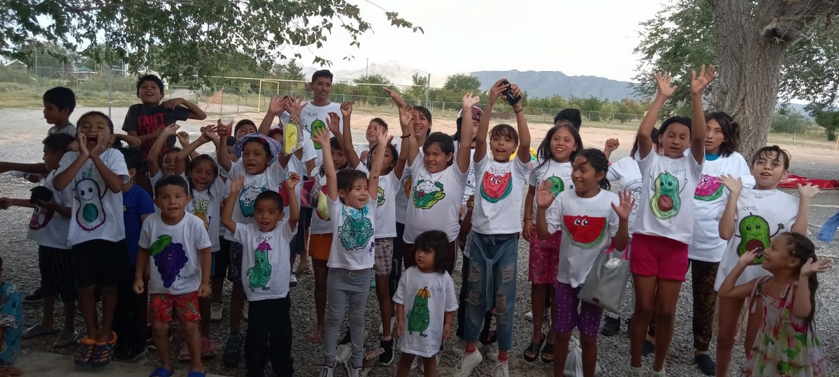Kids with t-shirts and hands in the air