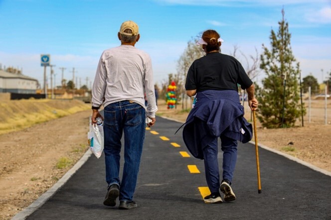 Two older people walking on the playa drain trail